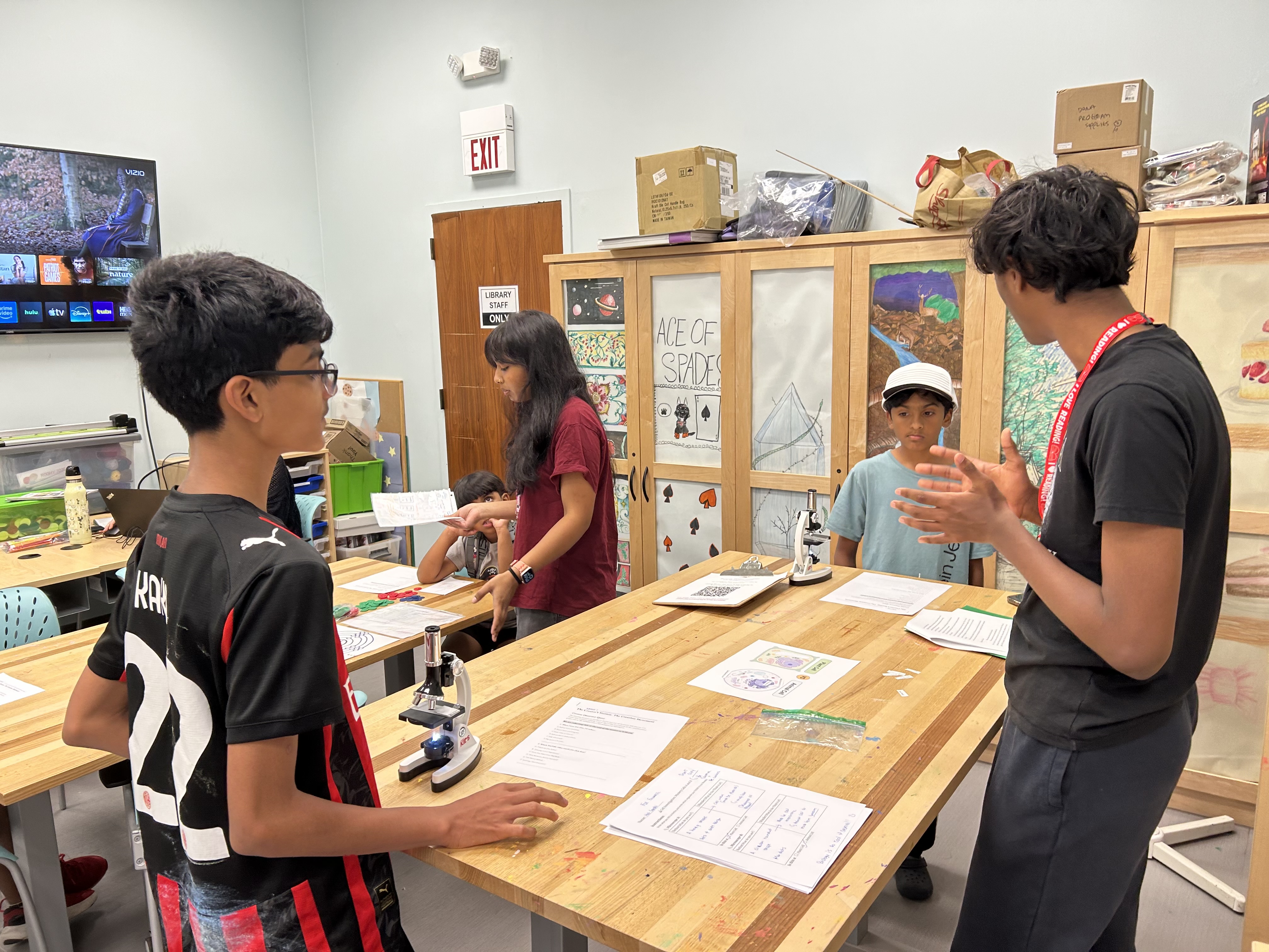 Students and mentors gathered around a hands-on workshop table